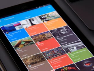 Close-up of a tablet displaying diverse content collections in a grid format.