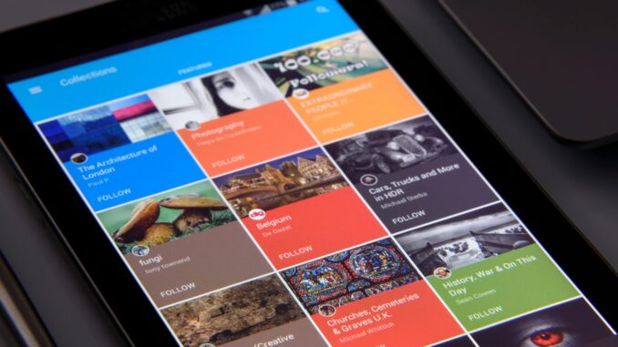 Close-up of a tablet displaying diverse content collections in a grid format.