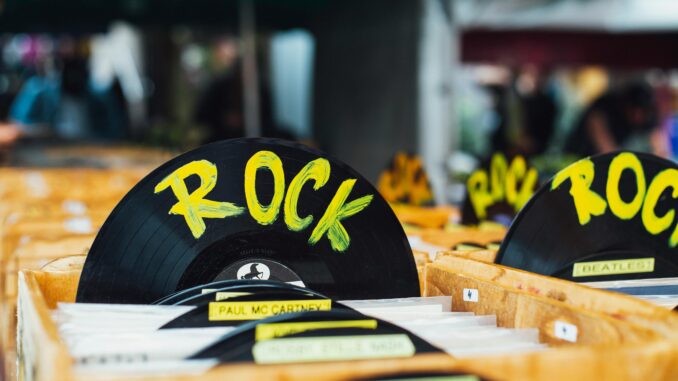 Colorful vinyl records labeled 'Rock' in a vintage music shop, perfect for music enthusiasts.