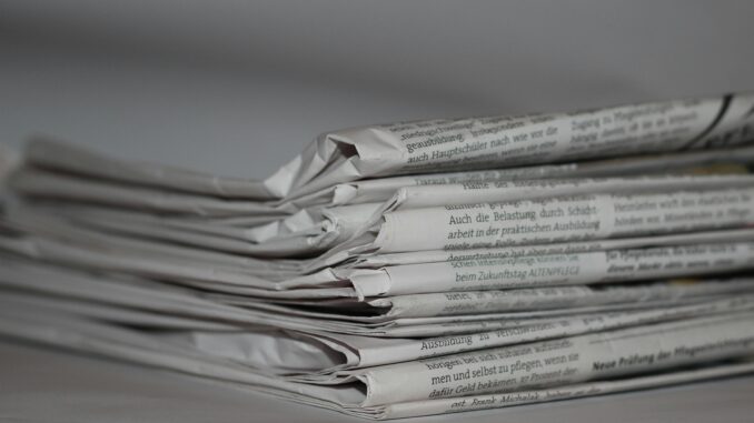 A close-up image of folded newspapers, perfect for news or journalism themes.
