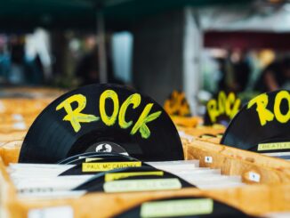 Colorful vinyl records labeled 'Rock' in a vintage music shop, perfect for music enthusiasts.
