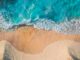 Stunning aerial view of turquoise waves hitting a sandy beach, perfect for nature lovers.
