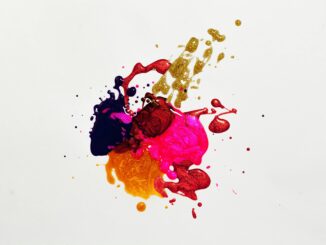 Colorful abstract paint splash on white background, capturing creative expression.