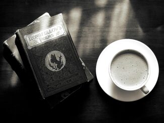 A captivating vintage still life of a coffee cup and Longfellow's poems book