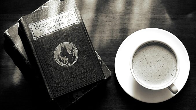 A captivating vintage still life of a coffee cup and Longfellow's poems book