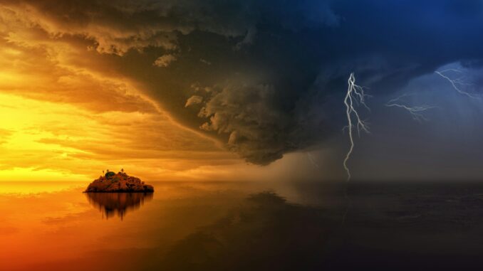 A stunning display of a stormy sunset with lightning striking over a solitary island.