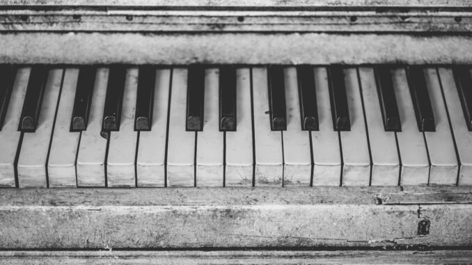 Black and white close-up of vintage piano keys, showcasing musical nostalgia.