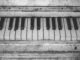 Black and white close-up of vintage piano keys, showcasing musical nostalgia.