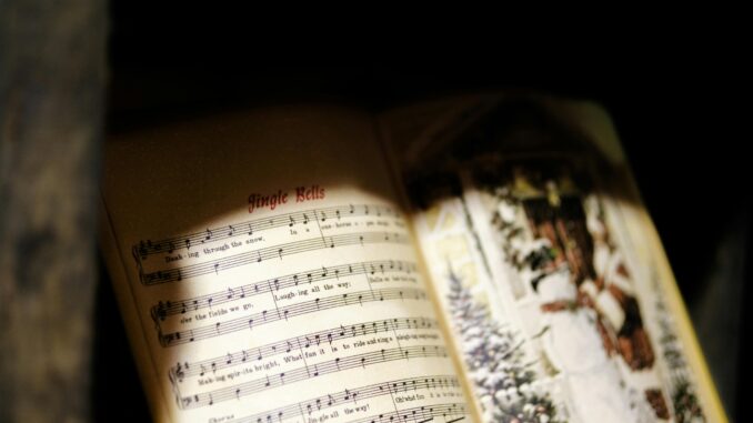 Close-up of a Jingle Bells music sheet with festive imagery, perfect for Christmas themes.