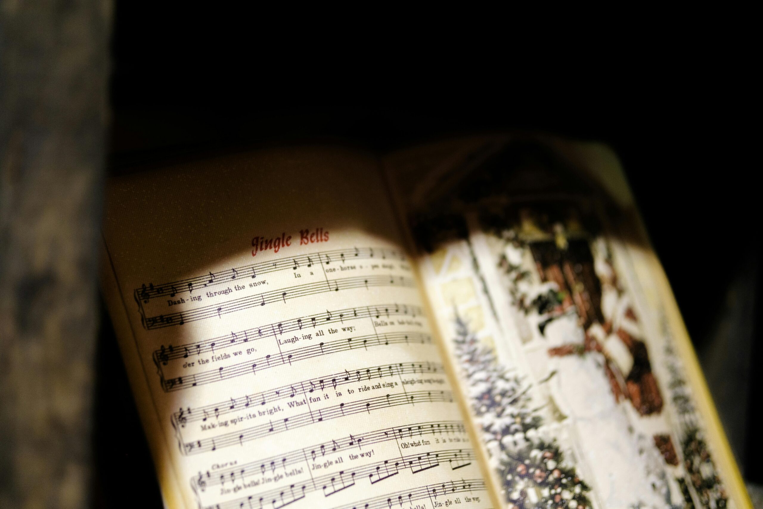Close-up of a Jingle Bells music sheet with festive imagery, perfect for Christmas themes.