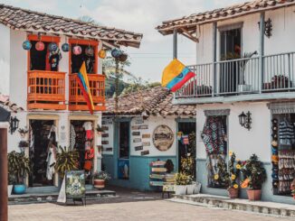 Charming Colombian street with vibrant shops and decorations.