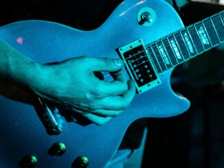 Electric guitar being played in a live music setting at a venue in Winston-Salem.