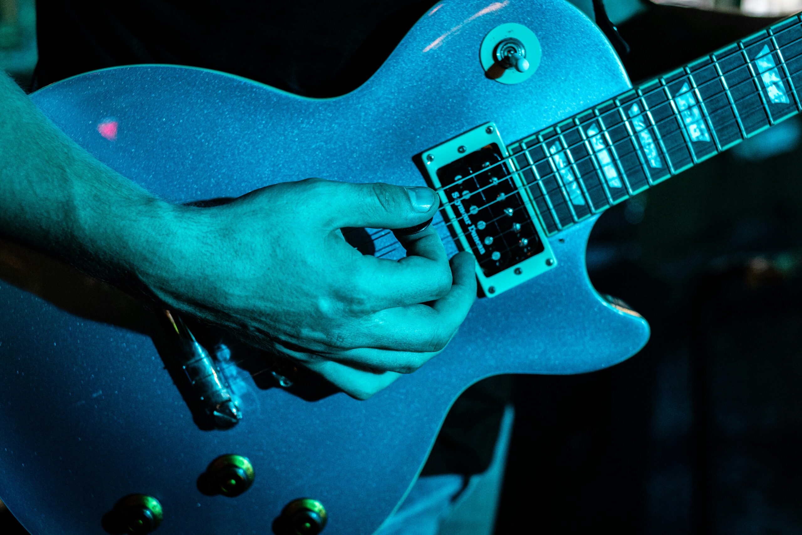 Electric guitar being played in a live music setting at a venue in Winston-Salem.