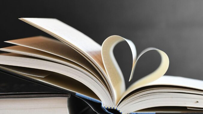 Open book with pages forming a heart, symbolizing love for reading and literature.