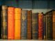 A row of vintage hardcover books with elegant bindings and classic literature titles.