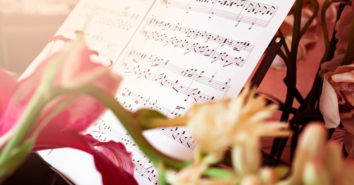 Close-up of sheet music surrounded by beautiful flowers, creating an artistic and serene still life.