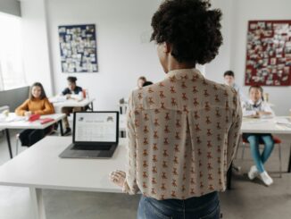 Female teacher engaging students in a classroom setting with diverse learners.
