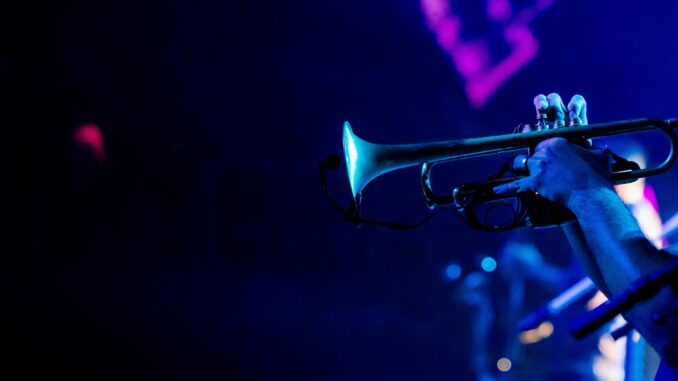 Vibrant image of a trumpeter playing during a live jazz concert, capturing the essence of musical performance.