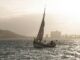 Elegant sailboat gliding across Lisbon's waters during a serene sunset.
