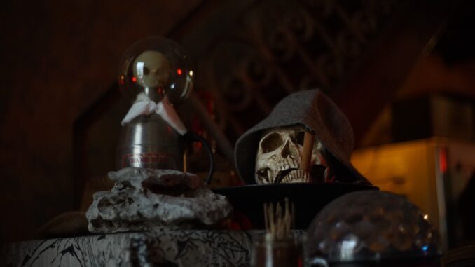 Eerie still life with a skull and decor for a spooky Halloween atmosphere.