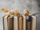 Artistic display of vintage books with dried leaves on top, evoking a nostalgic autumn mood.