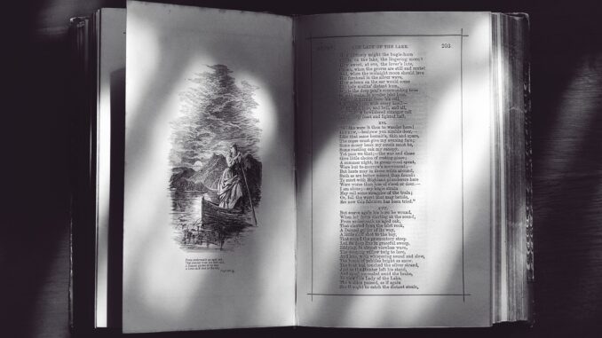 A black and white photo of an open book displaying text and an illustration.