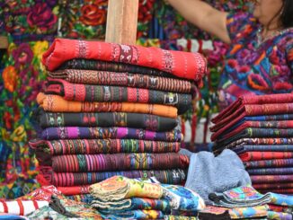 Vibrant handwoven textiles displayed at Sumpango market in Guatemala.