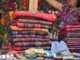Vibrant handwoven textiles displayed at Sumpango market in Guatemala.