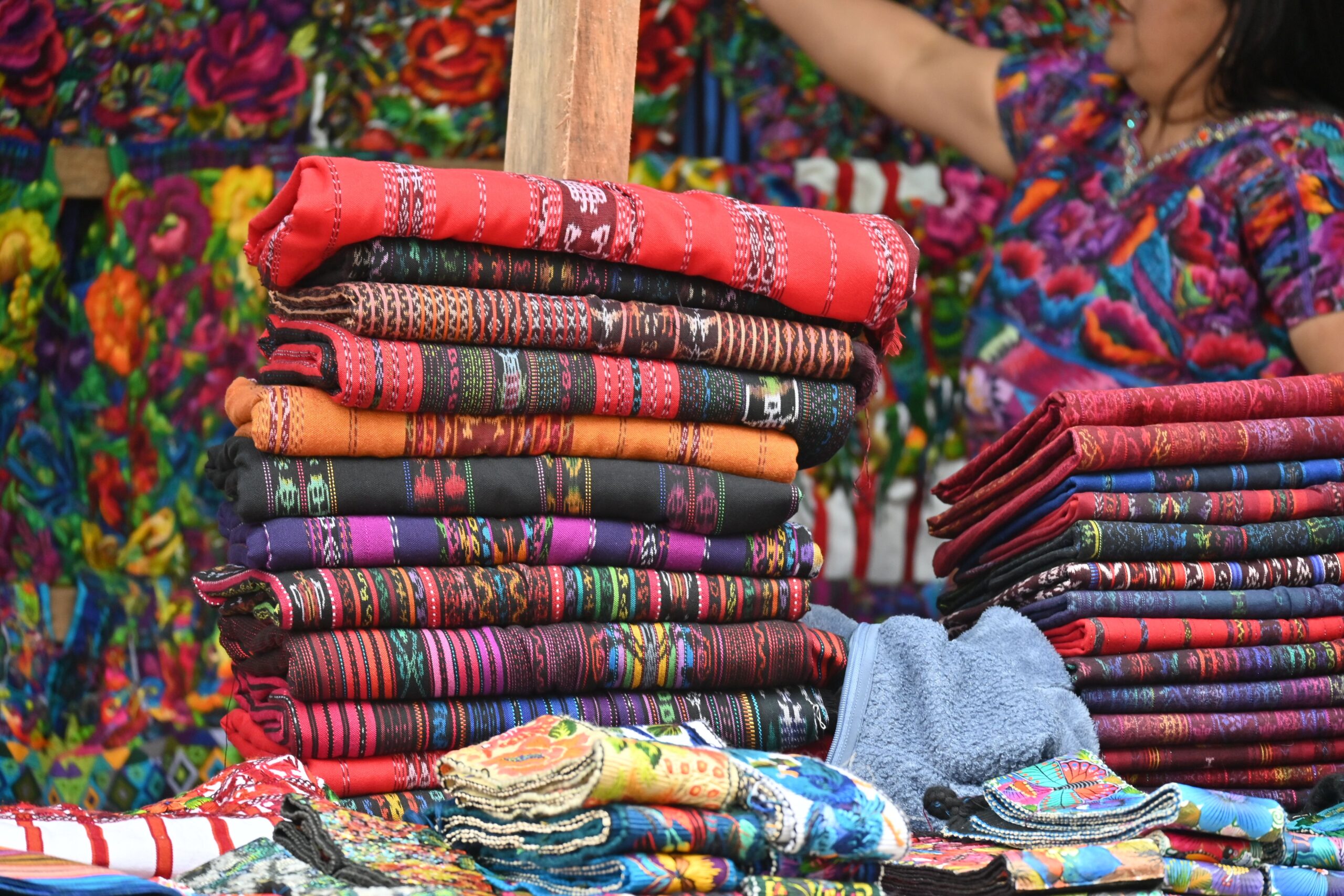 Vibrant handwoven textiles displayed at Sumpango market in Guatemala.
