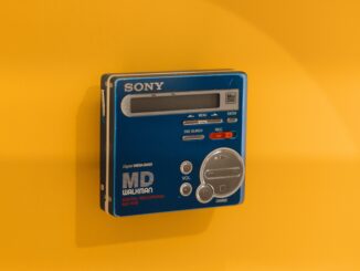 A classic Sony MD Walkman displayed against a vivid yellow backdrop, highlighting retro tech charm.