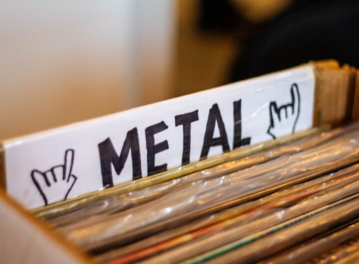 A detailed view of a box filled with metal genre vinyl records at a music store.