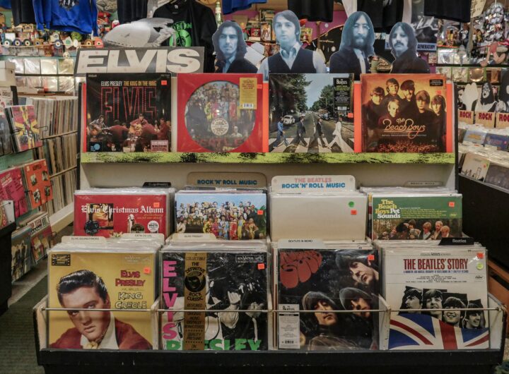 Retro vinyl collection featuring The Beatles and Elvis Presley in a classic music shop.
