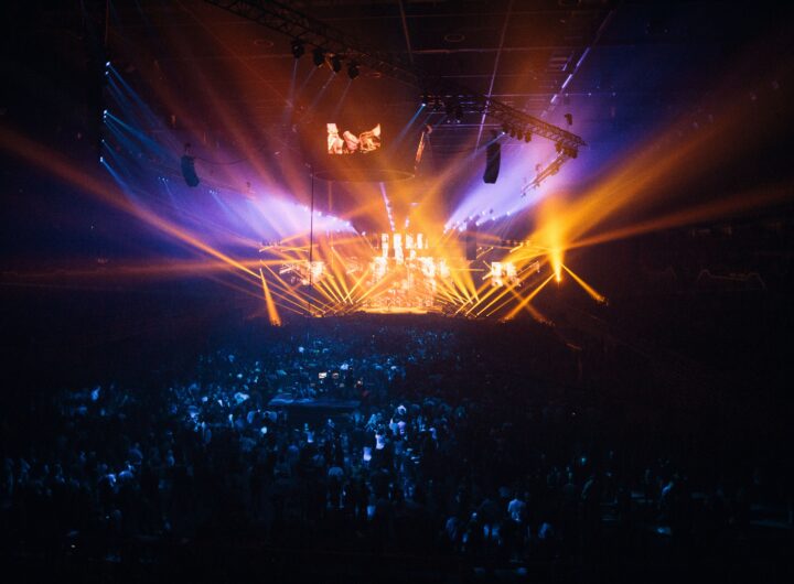 A vibrant live concert with dynamic lighting effects and an enthusiastic crowd.