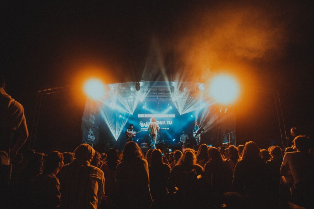 Energetic live music performance at night with a lively crowd.