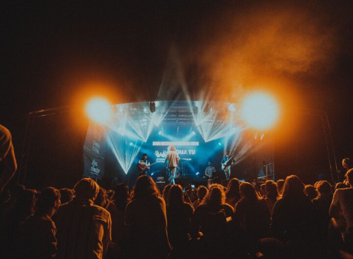 Energetic live music performance at night with a lively crowd.