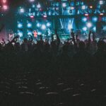Energetic crowd enjoying a live music concert with colorful lights in Contai, West Bengal, India.