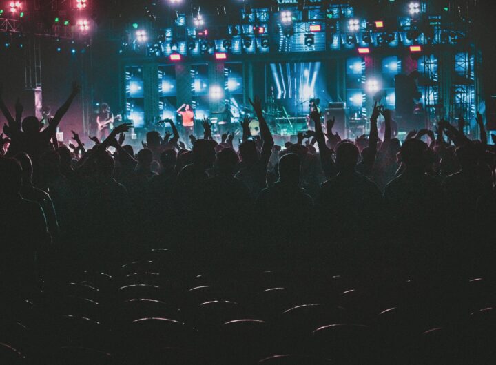 Energetic crowd enjoying a live music concert with colorful lights in Contai, West Bengal, India.