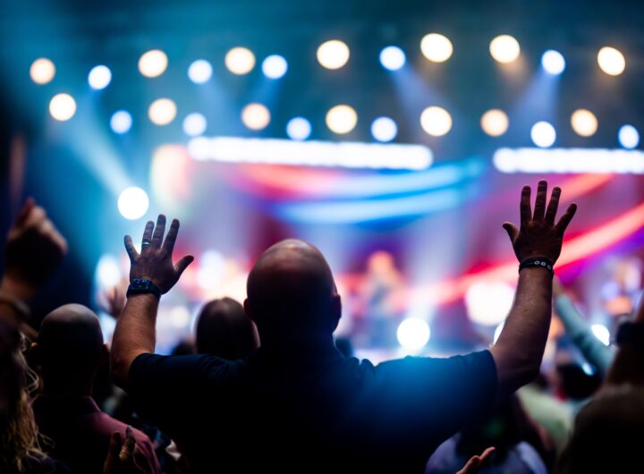 A vibrant scene of concert-goers enjoying a live music performance with colorful stage lights.
