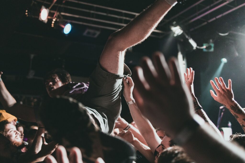 Vibrant scene of a crowd surfer at a live music concert, capturing the thrilling atmosphere.