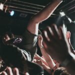 Vibrant scene of a crowd surfer at a live music concert, capturing the thrilling atmosphere.