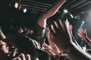 Vibrant scene of a crowd surfer at a live music concert, capturing the thrilling atmosphere.