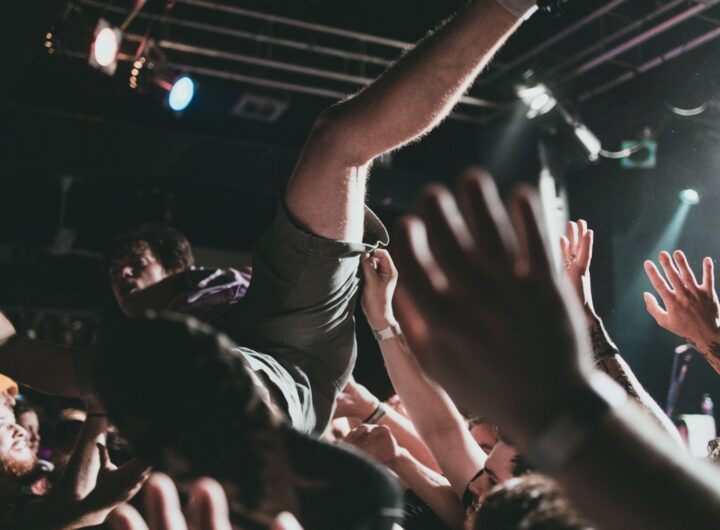Vibrant scene of a crowd surfer at a live music concert, capturing the thrilling atmosphere.